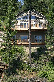 The lake side of the house has decks on both levels and windows galore! Hayden Lake House Vacation Rental, Hayden Lake, Idaho