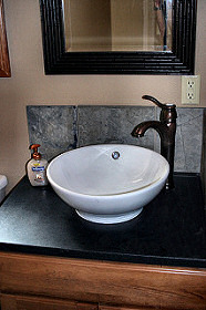 The sink is surrounded by gorgeous slate and a granite counter top. Hayden Lake House Vacation Rental, Hayden Lake, Idaho
