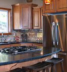 The gourmet kitchen includes top of the line appliances, granite countertops, the full compliment of pots, pans, and dishes, and plenty of cabinet space! The Lake House on Hayden Rental Home, Hayden Lake House, Idaho.